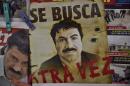 A poster with the face of Mexican drug lord Joaquin "El Chapo" Guzman, reading "Wanted, Again", in Mexico City on July 13, 2015