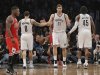 Brooklyn Nets' Williams, Lopez and Wallace tap hands as Chicago Bulls' Robinson walks off the court in the fourth quarter of their NBA basketball playoff game in New York