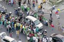 In this image from video, a crowd mobs the silver Fiat carrying Pope Francis through Rio de Janeiro on Monday, July 22, 2013. Ecstatic believers forced the closed Fiat to stop several times as they swarmed around during the drive from the airport to an official opening ceremony in the center of the city. (AP Photo)