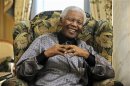 Former president of South Africa Mandela chats with Britain's Prime Minister Brown in London