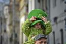 A child wearing a green hat with a shamrock takes part in a parade celebrating St Patrick's Day, in Bucharest, Romania, Sunday, March 16, 2014. Romanians and members of the Irish community marched downtown Bucharest celebrating St Patrick's Day. (AP Photo/Andreea Alexandru/Mediafax) ROMANIA OUT