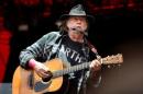 Canadian singer-songwriter Neil Young performs at the Orange Stage at the Roskilde Festival