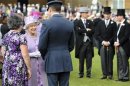 Britain's Queen Elizabeth greets guests at a garden party at Buckingham Palace, in central London