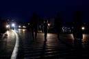 Migrants walk in the night along the highway towards the border with Austria