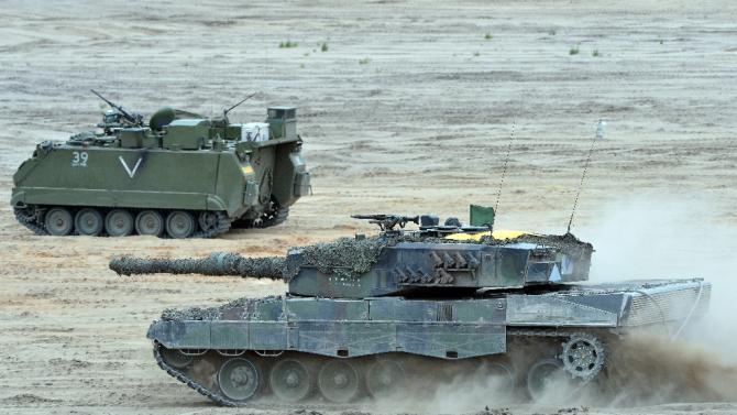 Tanks drive during a NATO Response Force exercise in Zagan, southwest Poland on June 18, 2015