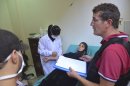 A U.N. chemical weapons expert meets a person affected by an apparent gas attack, at a hospital where she is being treated in Damascus' suburb of Zamalka