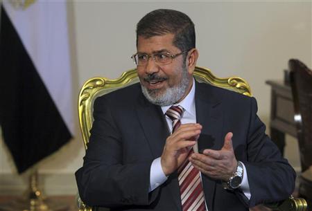 Egypt's President Mursi attends a meeting in Cairo