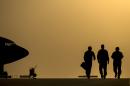 US Air Force members walk to their aircraft for an in-air refueling mission over Iraq on August 11, 2014