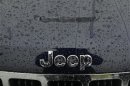 A wet Jeep logo and grill is shown at the Criswell Chrysler-Dodge-Jeep-Fiat-Ram truck dealership in Gaithersburg, Maryland