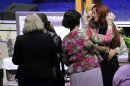 Rayne Perrywinkle, right, is consoled at the casket of her daughter, 8-year-old Cherish Perrywinkle, at Paxon Revival Center Church on Thursday, June 27, 2013 in Jacksonville, Fla. Cherish, who police say was targeted by a registered sex offender, was abducted and killed last Friday. (AP Photo/The Florida Times-Union, Will Dickey)