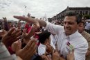 Presidential candidate Enrique Pena Nieto, of the Institutional Revolutionary Party (PRI), greets supporters as he campaigns in Toluca, Mexico, Wednesday, June 27, 2012. Mexico will hold its presidential election on Sunday. (AP Photo/Christian Palma)