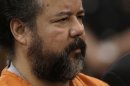 Ariel Castro stands before a judge during his arraignment on an expanded 977-count indictment Wednesday, July 17, 2013, in Cleveland. Castro is charged with kidnapping and raping three women over a decade in his Cleveland home. (AP Photo/Tony Dejak)