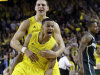 Michigan guard Trey Burke, foreground, and teammate forward Mitch McGary celebrate their 58-57 win over Michigan State in an NCAA college basketball game in Ann Arbor, Mich., Sunday, March 3, 2013. (AP Photo/Carlos Osorio)