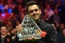 England's Ronnie O'Sullivan poses with the Paul Hunter Trophy after beating England's Joe Perry in the final to win the Masters snooker tournament at Alexandra Palace in London, on January 22, 2017