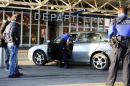 County of Geneva police officers check a car outside Cointrin airport in Geneva