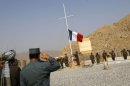 French soldiers lower the French national flag during an official handover ceremony to the Afghan National Army