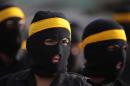 Iraqi Shiite fighters in uniforms take part in a parade on June 21, 2014 in Baghdad