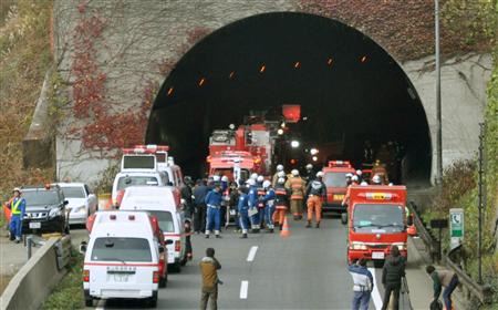 Police officers and firefighters gather in front of the Sasago Tunnel on the Chuo Expressway in Otsuki, Yamanashi prefecture, in this photo taken by Kyodo December 2, 2012. REUTERS/Kyodo