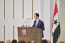 Syria's president Bashar al-Assad speaks during his meeting with the heads and members of public organizations and professional associations in Damascus, Syria