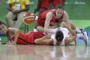 Canada forward Miranda Ayim, left, guard Kim Gaucher, top, chase the loose ball with Spain forward Marta Xargay during the first half of a women's basketball game at the Youth Center at the 2016 Summer Olympics in Rio de Janeiro, Brazil, Sunday, Aug. 14, 2016. (AP Photo/Carlos Osorio)