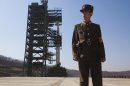 FILE - In this April 8, 2012 file photo, a North Korean soldier stands in front of the country's Unha-3 rocket, slated for liftoff between April 12-16, at Sohae Satellite Station in Tongchang-ri, North Korea. Rocket sections are apparently being trucked into North Korea's northwest launch site, but some analysts are asking whether it's just a calculated bluff meant to jangle the Obama administration and influence South Korean voters ahead of Dec. 19 presidential elections in three weeks. (AP Photo/David Guttenfelder, File)
