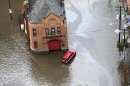 A firehouse is surrounded by floodwaters in the wake of superstorm Sandy on Tuesday, Oct. 30, 2012, in Hoboken, N.J. Sandy, the storm that made landfall Monday, caused multiple fatalities, halted mass transit and cut power to more than 6 million homes and businesses. (AP Photo/Mike Groll)