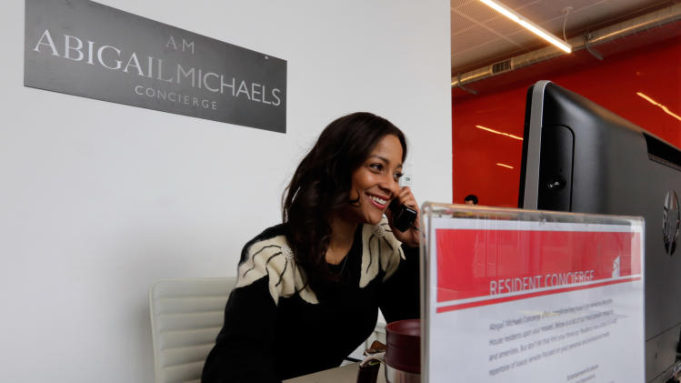Zayna Abdul, 34, an Abigail Michaels concierge, works at her desk in ...