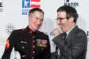 Marine corporal Aaron Mankin, left, and John Oliver appear at the 9th Annual Stand Up For Heroes, presented by the New York Comedy Festival and The Bob Woodruff Foundation, at the Theater at Madison Square Garden on Tuesday, Nov. 10, 2015, in New York. (Photo by Michael Zorn/Invision/AP)