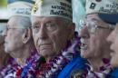 Pearl Harbor survivor Mal Middlesworth, center, sits with other Pearl Harbor survivors before the start of ceremony commemorating the 72nd anniversary of the attack on Pearl Harbor, Saturday, Dec. 7, 2013, in Honolulu. (AP Photo/Marco Garcia)
