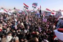 Protesters chant slogans against Iraq's Shiite-led government as they wave national flags during a demonstration in Ramadi, 70 miles (115 kilometers) west of Baghdad, Iraq, Wednesday, Dec. 26, 2012. Thousands of Iraqi demonstrators massed in a Sunni-dominated province west of Baghdad Wednesday, determined to keep up the pressure on a Shiite-led government that many accuse of trying to marginalize them. (AP Photo/ Hadi Mizban)