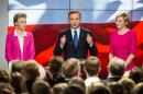Andrzej Duda, presidential candidate of Law and Justice (PiS) right wing opposition party, addresses his supporters next to his wife Agata (R) and daughter Kinga (L) in Warsaw on May 10, 2015