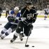 Los Angeles Kings defenseman Drew Doughty (8) moves the puck as he is chased by St. Louis Blues left winger Jaden Schwartz (9) in the first period of Game 4 of the NHL Western Conference Stanley Cup hockey playoff series in Los Angeles, Monday, May 6, 2013. (AP Photo/Reed Saxon)