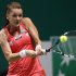 Poland's Radwanska hits a return to Williams of the U.S. during their semifinals WTA tennis championships