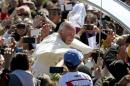 Pope Francis greets people as he leaves after celebrating a Mass at the Cristo Redentor square in Santa Cruz