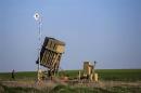 An Israeli soldier walks near the launcher of an Iron Dome missile interceptor battery deployed in the southern Israeli coastal city of Ashkelon