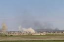Smoke rises around the Syrian southern town of Bosra al-Sham