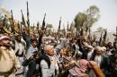 Tribesmen loyal to the Houthi movement raise their weapons as they gather to show support to the movement in Sanaa, Yemen