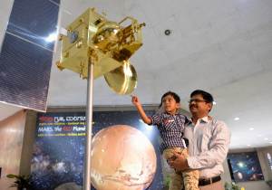 Visitors look at a scale model of India's Mars Orbiter&nbsp;&hellip;