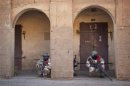 Malian soldiers crouch behind arched doorways during gun battles with Islamist insurgents in the northern city of Gao