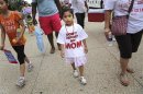 A girl wears a "Don't Deport My Mom t-shirt" as she joins immigrants and activists as they chant and march to urge congress to act on immigration reform, on Capitol Hill in Washington