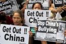 Protesters from the Socialista National Confederation of Labor activist group display placards during a rally over the South China Sea disputes with China, outside the Chinese Consulate in Makati City