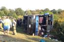 Passengers from a tour bus are treated for injuries near the overturned bus at the Tybouts Corner on ramp from southbound Del. 1 to Red Lion Road. Officials at the scene reported one fatality and several injuries from the crash the 4:20 p.m. crash on Sunday, Sept. 21, 2014, in Bear, Del. (AP Photo/The Wilmington News-Journal, John J. Jankowski)