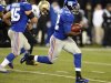 New York Giants running back David Wilson rushes past New Orleans Saints defenders to score a touchdown on a 97-yard kickoff return during the first half of an NFL football game, Sunday, Dec. 9, 2012, in East Rutherford, N.J. (AP Photo/Bill Kostroun)