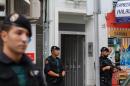 Spanish police stand guard outside the house of an 18-year-old Moroccan woman suspected of recruiting other women via the Internet to the jihadist group Islamic State (IS), in Gandia on September 5, 2015