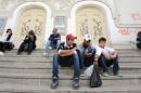 Tunisian youth sit on stairs outside the theater on Habib Bourguiba Avenue on November 6, 2013 in Tunis