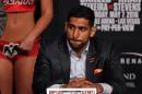 England's Amir Khan looks on as boxer Saul 'Canelo' Alvarez from Mexico speaks during their final press conference at the MGM Grand in Las Vegas, Nevada on May 4, 2016