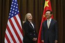 U.S. Secretary of State Clinton and China's Foreign Minister Yang smile during their meeting in Beijing