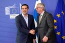 Prime Minister of Greece Alexis Tsipras (L) shakes hands with European Commission President Jean-Claude Juncker in Brussels, on June 3, 2015