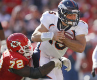 El quarterback Tim Tebow de los Broncos de Denver es capturado por Glenn Dorsey de los Chiefs de Kansas City el domingo 13 de noviembre del 2011. Pese a una modesta actuación de Tebow, los Broncos se llevaron una de las victorias que evidencian el carácter impredecible de los equipos en la NFL en el noviembre del 2011. (Foto AP/Ed Zurga)