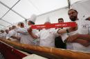 French and Italian bakers show a note reading 120 meters, at Expo 2015, in Rho, near Milan, Italy, Sunday, Oct. 18, 2015. A judge from the Guinness World Record Judge has certified a 122-meter -long (400-foot-long) baguette baked at the Milan Expo 2015 World's Fair as the longest in the world. The Italian maker of Nutella, Ferrero, backed the enterprise to beat the 111-meter record held by a French supermarket chain. (AP Photo/Antonio Calanni)